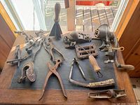 Overview of assorted antique iron tools on tabletop