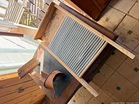 Overview showing Economy Zinc washboard and adjacent clothing wringer parts on table