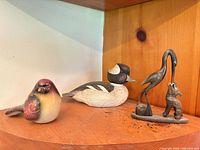 All three figurines on shelf showing size relation and condition