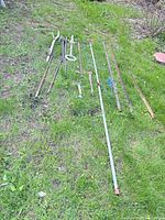 Wide view of all garden tools laid on grass