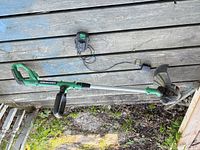 Full view of Certified 20V Max string trimmer with charger mounted above and cord visible
