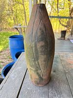 Full view of tall sculptural vase on table