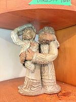 front view of stoneware family sculpture