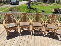 Front view of four rattan armchairs on deck