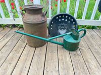 Milk can, watering can, tractor seat grouped on deck