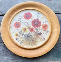 Front view showing wood rim and pressed flower design