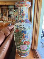 Front view of tall Chinoiserie porcelain vase showing peacock and floral design