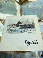 Front cover of softcover art book with winter barn painting and Keirstead title