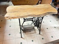 Top view showing live edge wood slab and Singer base