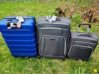 Front view of three suitcases on grass