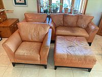Loveseat, two armchairs and ottoman grouped together