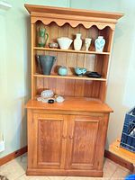 Full view of pine open shelf cupboard with contents (not included)