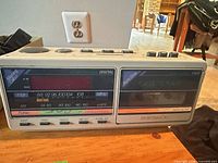 Front view of AudioSonic PW91 showing clock display, radio scale, cassette deck and control layout