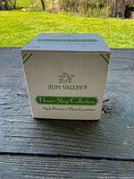 Front view of boxed Sun Valley Flower Shop Collection Apple Blossom candle, item #5909 visible