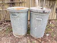 Front view of both galvanized cans with lids in place
