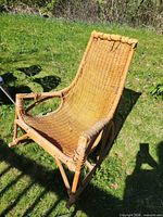 Full view of wicker rattan rocking chair outdoors