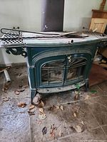 Front view of green enamel wood-burning stove