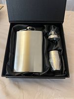 Flask, funnel, shot glass inside presentation box