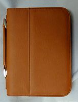 Front view of closed rawhide faux leather cover showing handle and zipper pulls