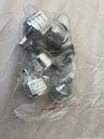 Plastic bag containing nine stainless steel funnels