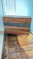 Front view of dresser showing reclaimed wood panels and metal hairpin legs