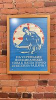 Full view of framed poster on brick wall