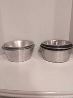 Stacked view of two sets of pans, tube pans on right, round pans on left