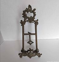 Front view of ornate brass easel