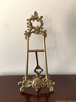 Front view of ornate brass easel