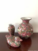 front view of large vase, small vase, duck figurine
