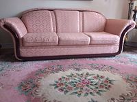 Front view of full sofa showing upholstery, cushions and wood trim