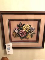 Front view of framed 3-D floral artwork in wood frame
