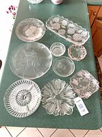 All nine pressed glass pieces arranged on countertop
