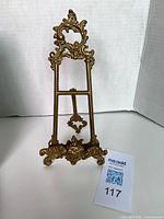 Front view of ornate brass easel stand