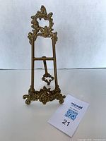 Front view of ornate brass easel showing full design