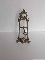 Front view of brass ornate easel