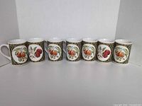 Front view of 7 mugs showing peach design and gold-trim lattice