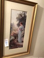Full view of framed print showing gold frame and artwork