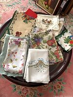 Group of assorted folded linens on table