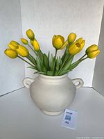 Vase filled with yellow tulips, front view