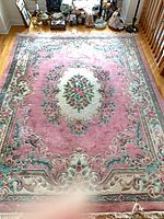 Full view of Aubusson-style rug on floor showing overall design and colors