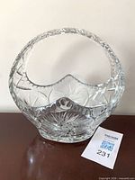 Front view of clear crystal basket-form bowl showing handle and pinwheel cuts