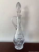 Full view of decanter front angle showing handle, stopper, pinwheel cuts