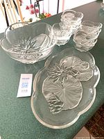 Overview of platter, large bowl, and stack of small bowls on countertop