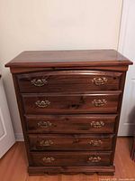 Front view of dark brown 5-drawer pine dresser with brass-tone pulls