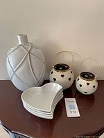 Front view of all items: vase, four plates, two lanterns