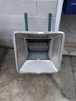 Top view of fruit crusher showing hopper and stand legs