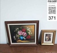 Both framed artworks side by side on surface