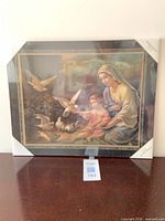Front view of framed Madonna and Child print still in shrink wrap with protective corners