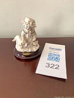 Front view of Giuseppe Armani Puppy Love figurine with MaxSold ID card
